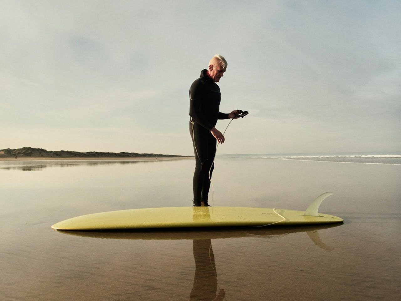 man preparing to surf at beach