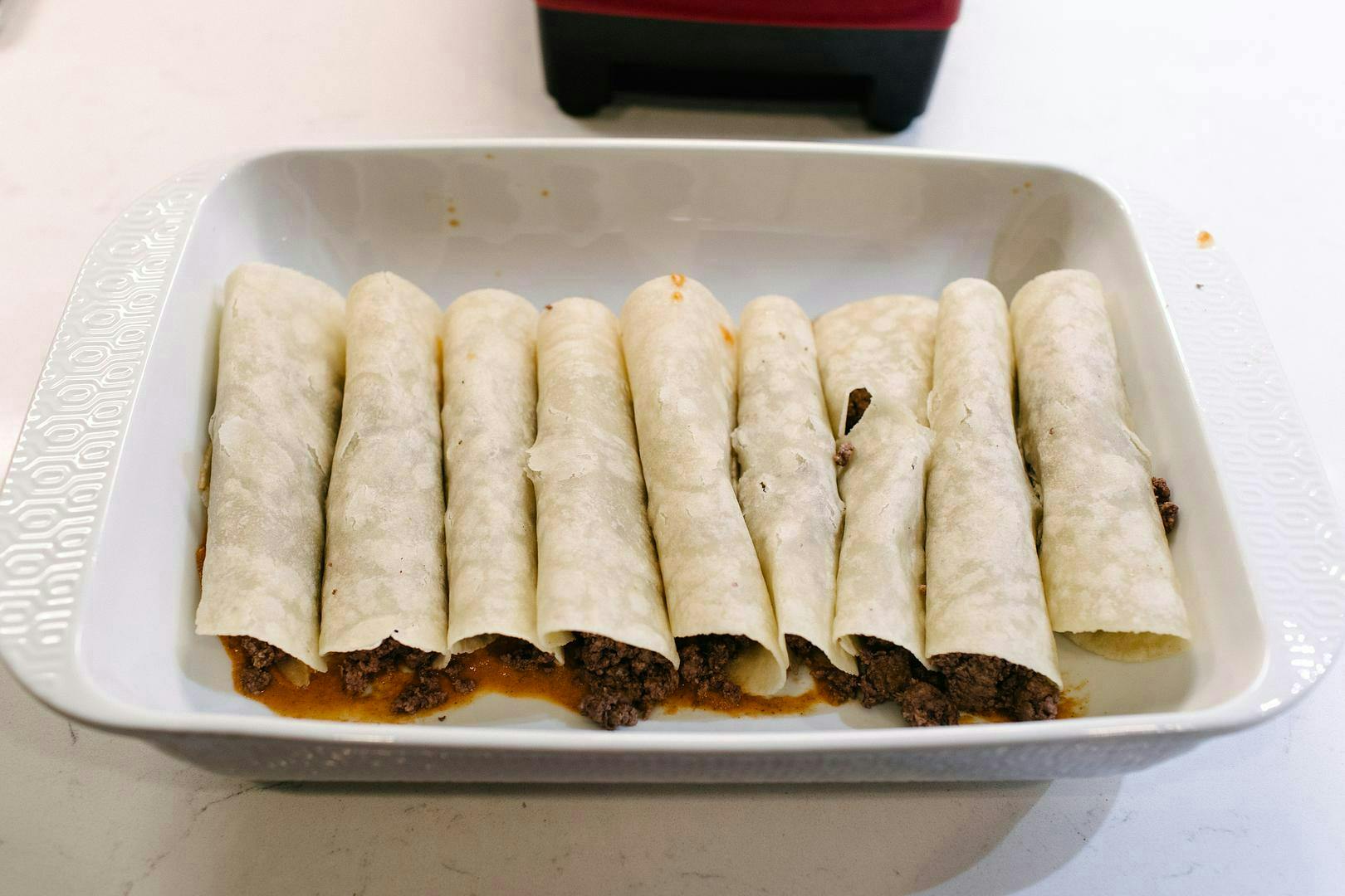 rolled-up enchiladas in baking dish