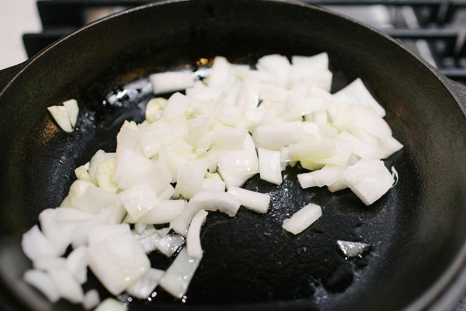 sauteeing onions in a pan