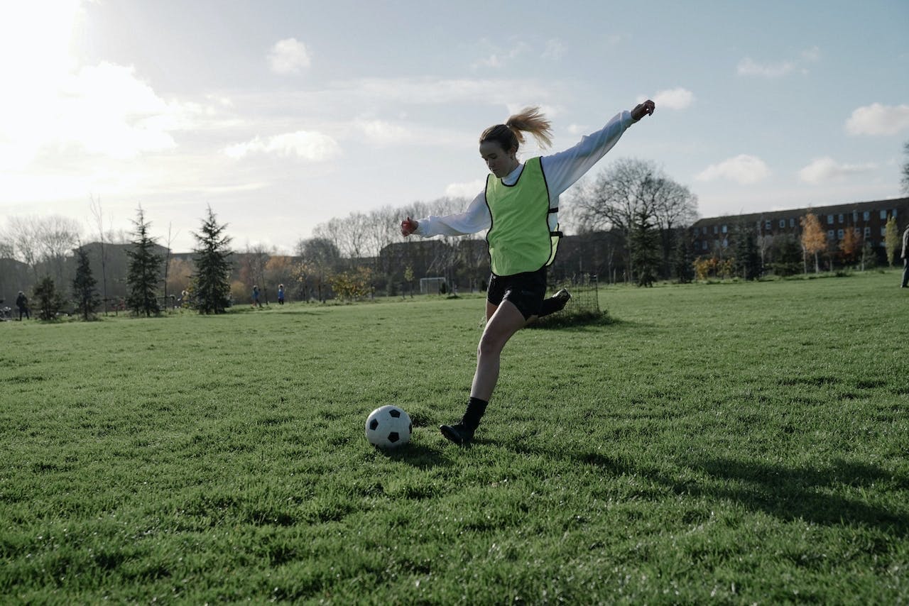 woman kicking a soccer ball