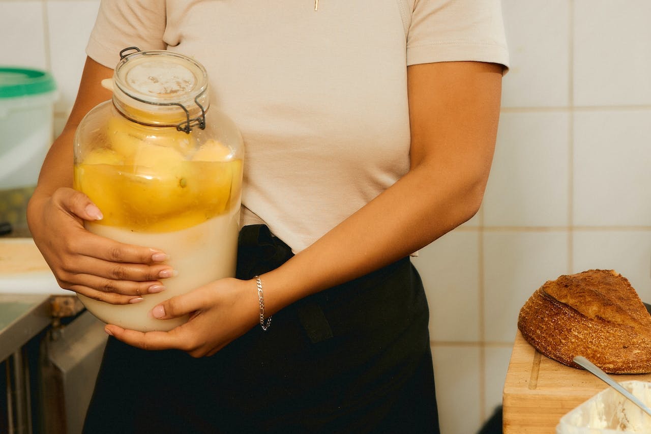 woman holding jar of preserved lemons
