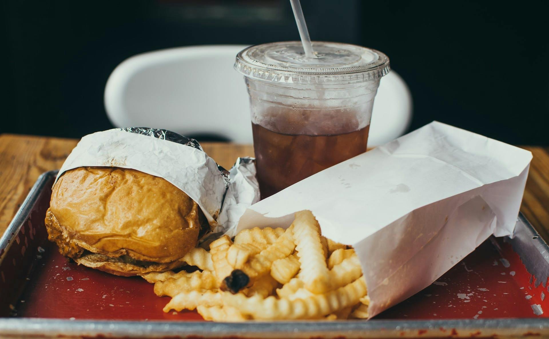burger, fries, and soda on a tray