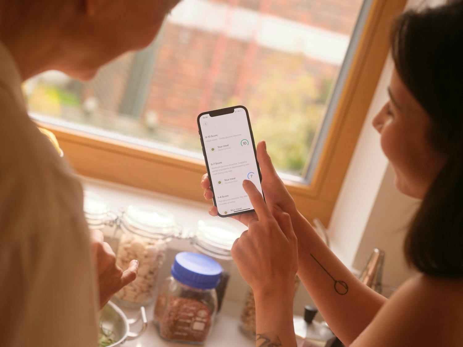 two people looking at insights from a continuous glucose monitor in the veri mobile app